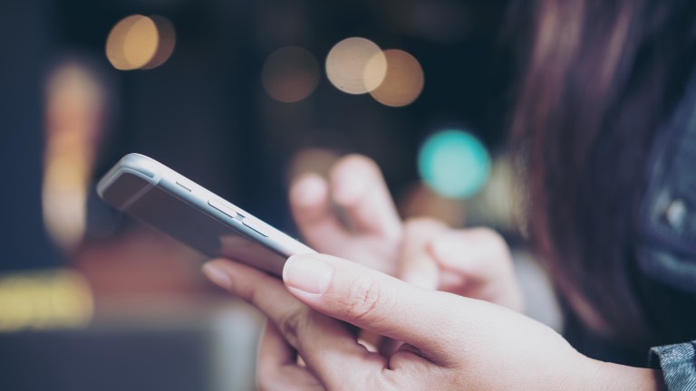 business-woman-holding-touching-smart-phone